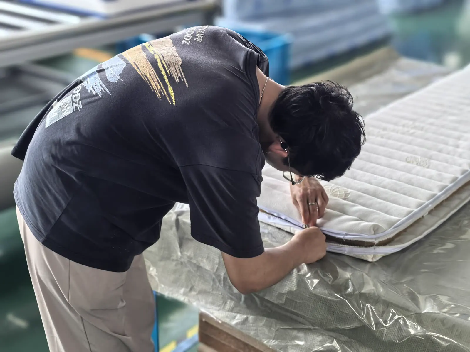 Worker checking mattress detail