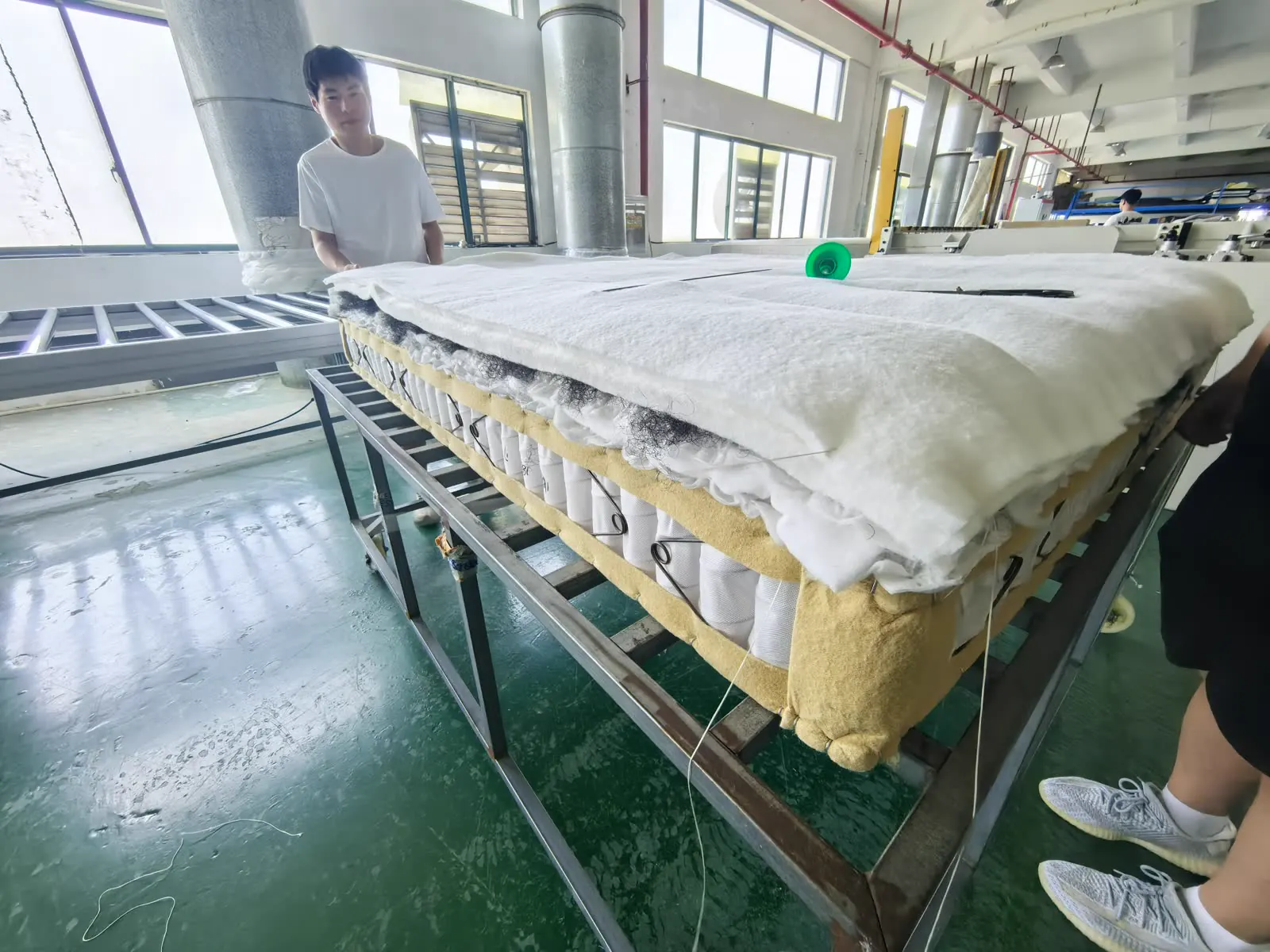 Mattress layers and spring construction being assembled on the production line