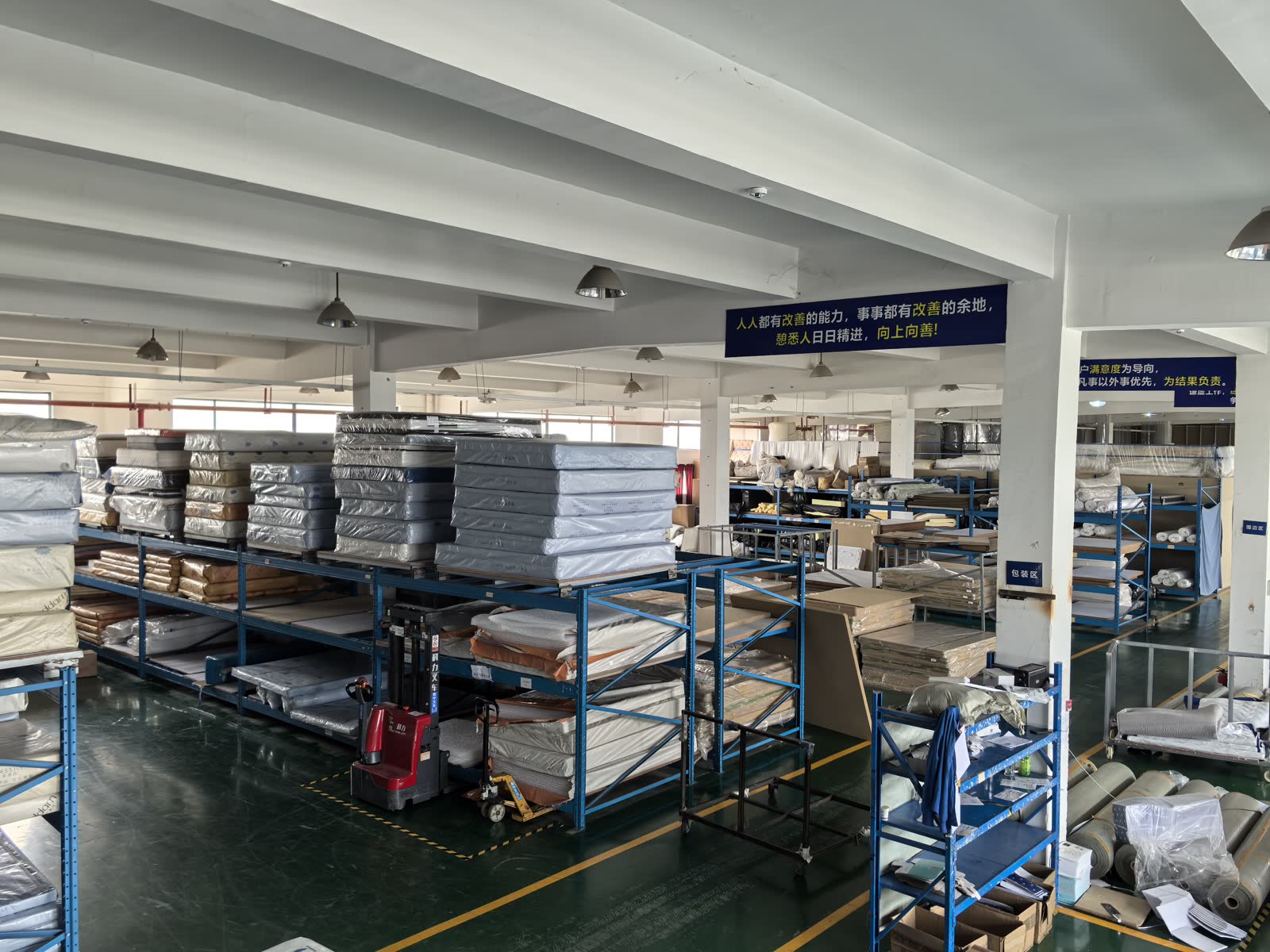 packed mattress goods arranged in the factory warehouse